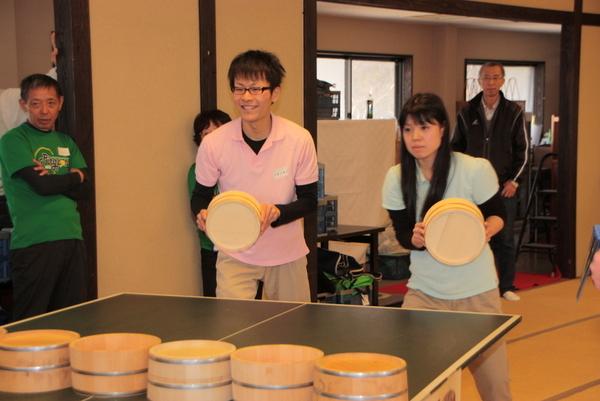 桶を持って構えている男女の写真